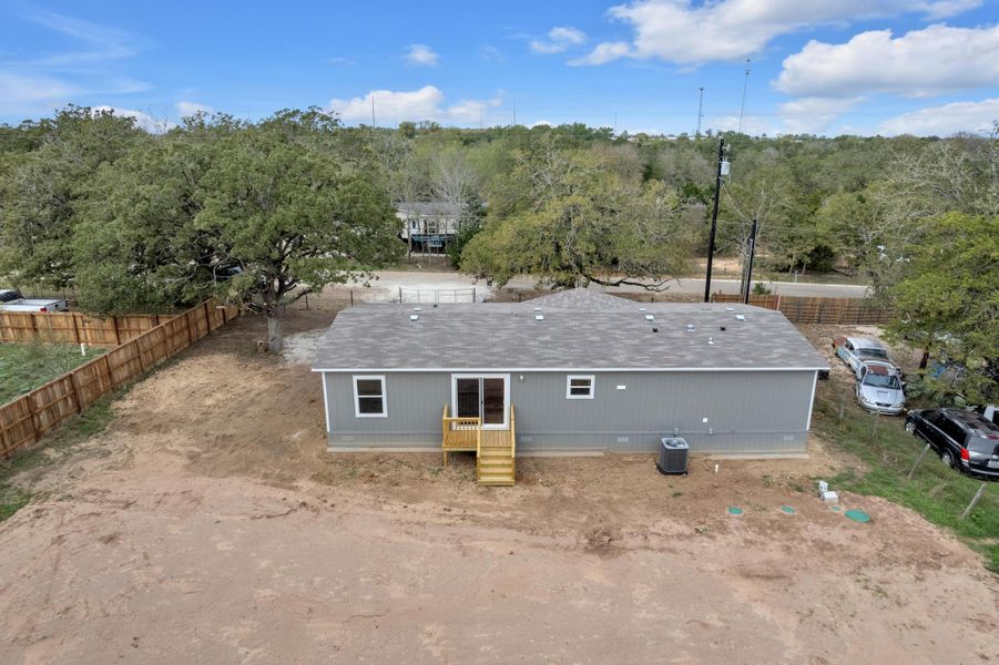 Rear view of property featuring a shingled roof
