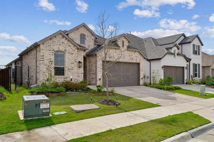 Front exterior of a new home in Cottages of Celina, Celina, TX, highlighting curb appeal (Image 2). Front exterior of a new home in Cottages of Celina, Celina, TX, highlighting curb appeal (Image 2).