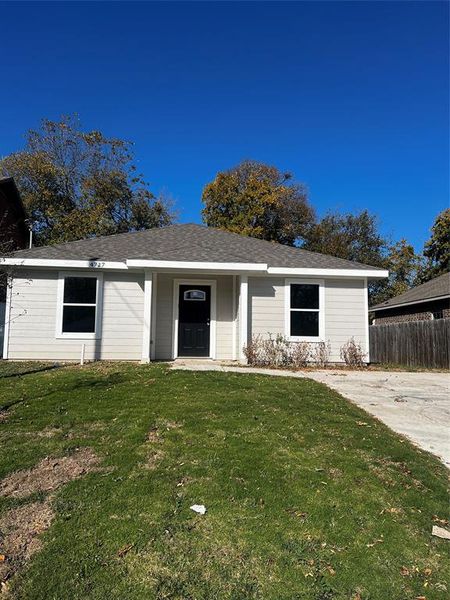 Single story home featuring a front lawn