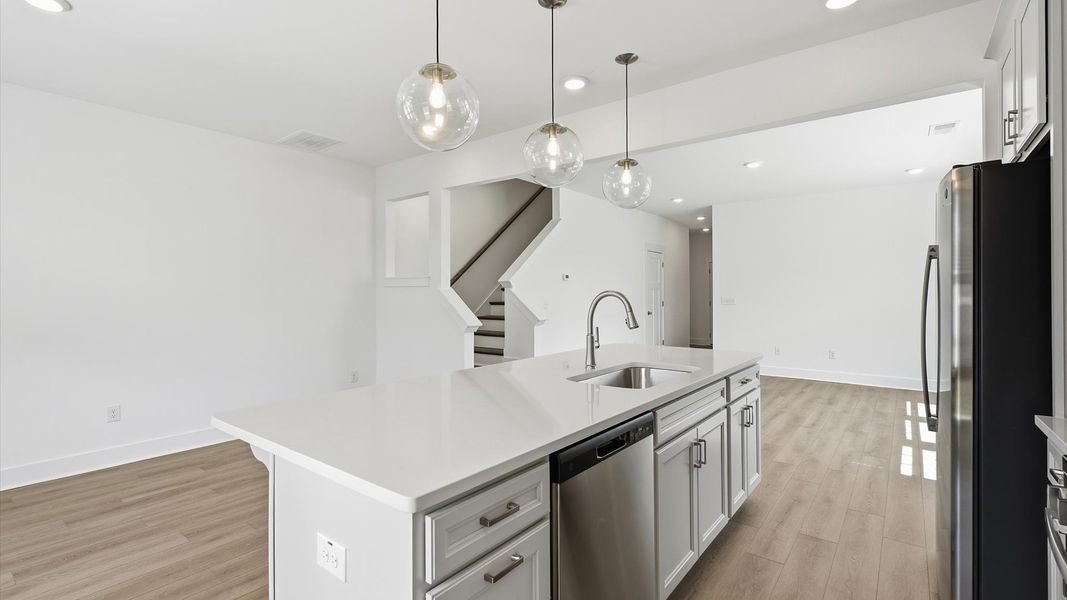 Notable kitchen space with elegant pendant lighting and a large island perfect for entertaining at Barton Hollow