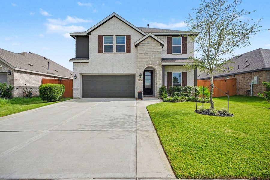 Beautiful two-story brick and stone elevation with a spacious driveway, manicured landscaping, and inviting curb appeal. Beautiful two-story brick and stone elevation with a spacious driveway, manicured landscaping, and inviting curb appeal.