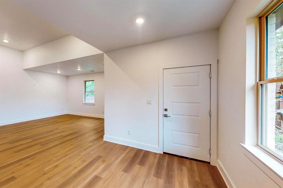 Empty room with plenty of natural light and light wood-type flooring