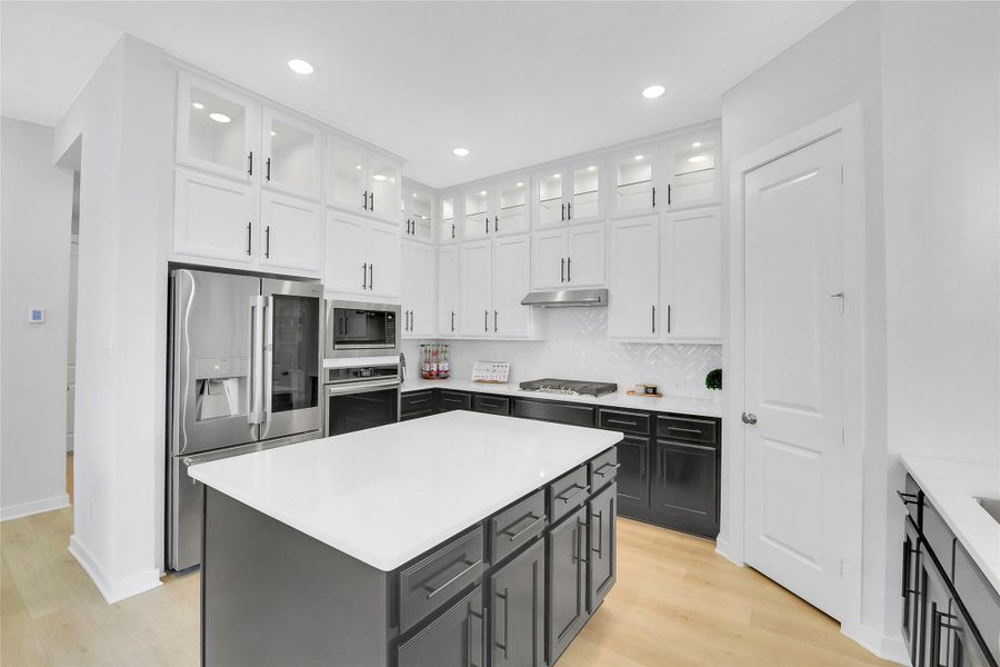 So many cabinets! And this home is upgraded with the upper cabinets, with glass fronts and interior lighting.