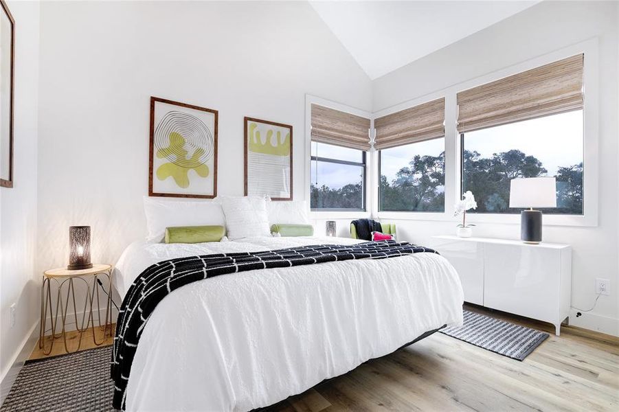 This secondary bedroom is spacious and inviting with ample natural light and a serene ambiance.