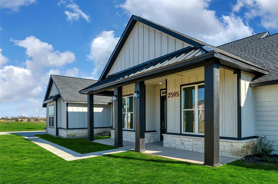 Rear view of property featuring a lawn