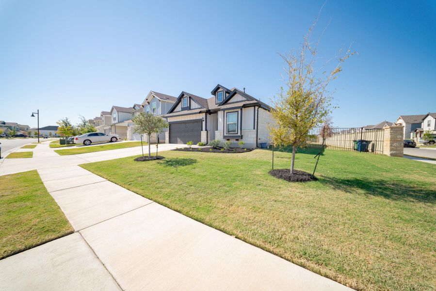 View of front of house with a residential view, concrete driveway, board and batten siding, and a garage View of front of house with a residential view, concrete driveway, board and batten siding, and a garage