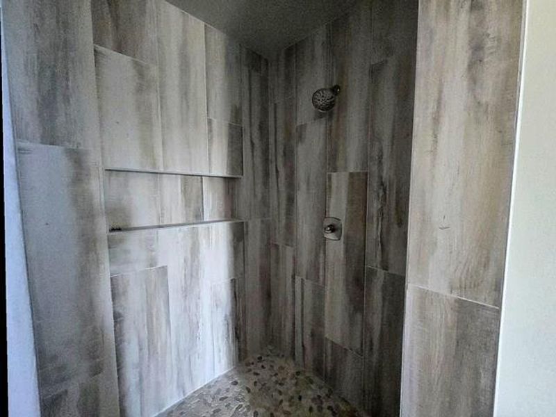 Full bath with tiled shower
