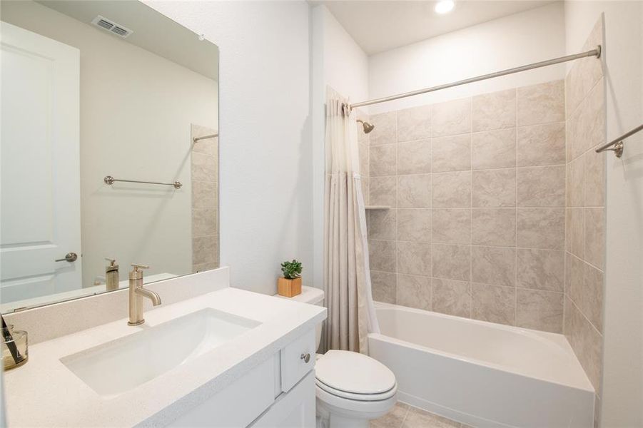 Designed for comfort and independence, the private ensuite bath features quartz countertops, modern finishes, and convenient access from the multi-generational suite, creating a true retreat for guests or extended family. Designed for comfort and independence, the private ensuite bath features quartz countertops, modern finishes, and convenient access from the multi-generational suite, creating a true retreat for guests or extended family.