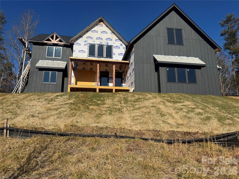 Front elevation in progress. Exterior will feature white artisan stone, black metal overhangs, and a custom double entry door. Front elevation in progress. Exterior will feature white artisan stone, black metal overhangs, and a custom double entry door.