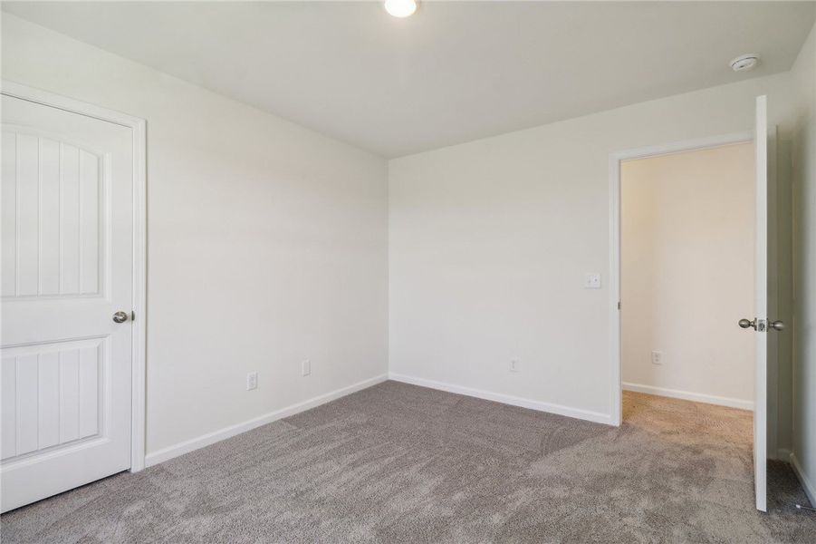 This spacious bedroom offers ample natural light a This spacious bedroom offers ample natural light a