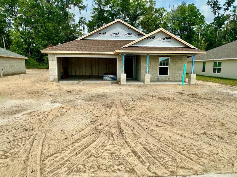 Front exterior of a new home in Oak Hill Plantation, Ocala, FL, highlighting curb appeal (Image 1).