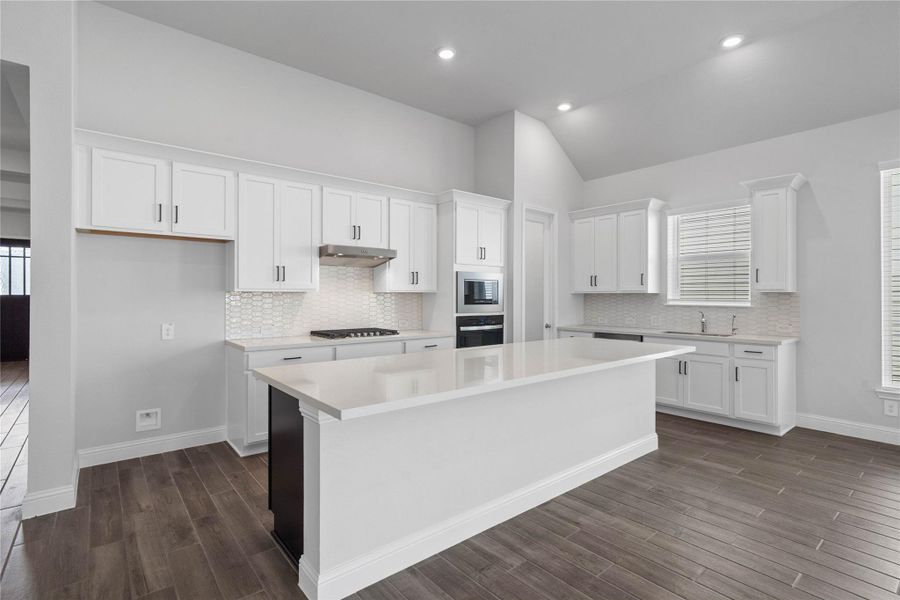 A kitchen island with a breakfast bar combines meal preparation with a casual dining area. A kitchen island with a breakfast bar combines meal preparation with a casual dining area.