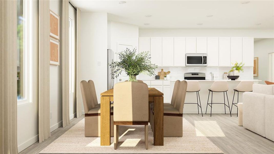 Dining space with light hardwood / wood-style flooring and sink