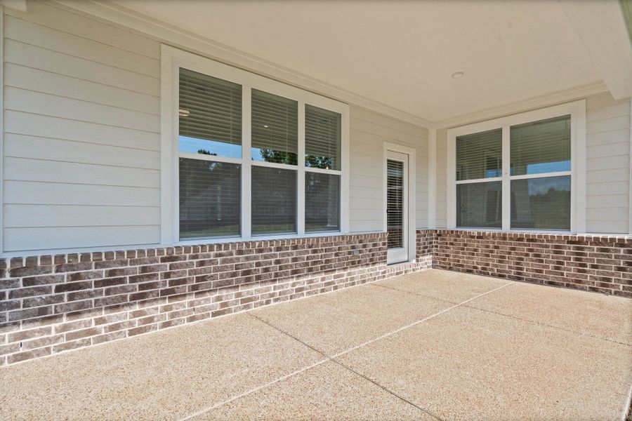 Covered patio featuring an exposed aggregate concrete floor Covered patio featuring an exposed aggregate concrete floor
