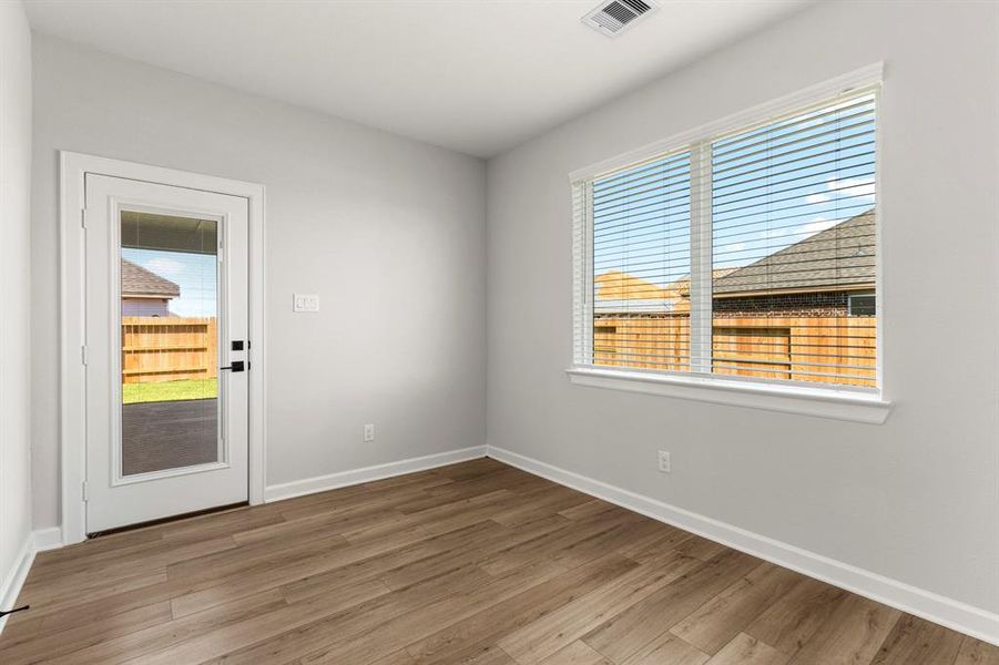 The dining room, located just off the kitchen, overlooks the back patio and backyard.