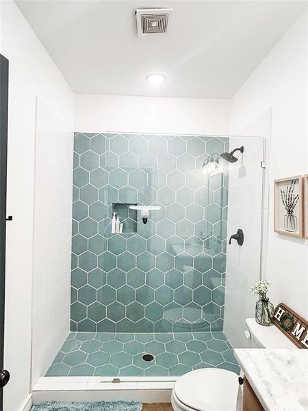 Full bath featuring vanity and a stall shower Full bath featuring vanity and a stall shower