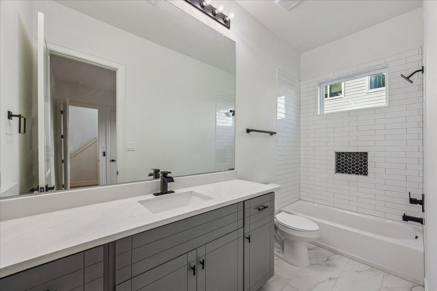 Ensuite bathroom featuring sleek modern fixtures and a stylish tub/shower combination, offering both functionality and contemporary appeal. Thoughtfully designed with clean lines and quality finishes, creating a comfortable and inviting space for daily living. Ensuite bathroom featuring sleek modern fixtures and a stylish tub/shower combination, offering both functionality and contemporary appeal. Thoughtfully designed with clean lines and quality finishes, creating a comfortable and inviting space for daily living.