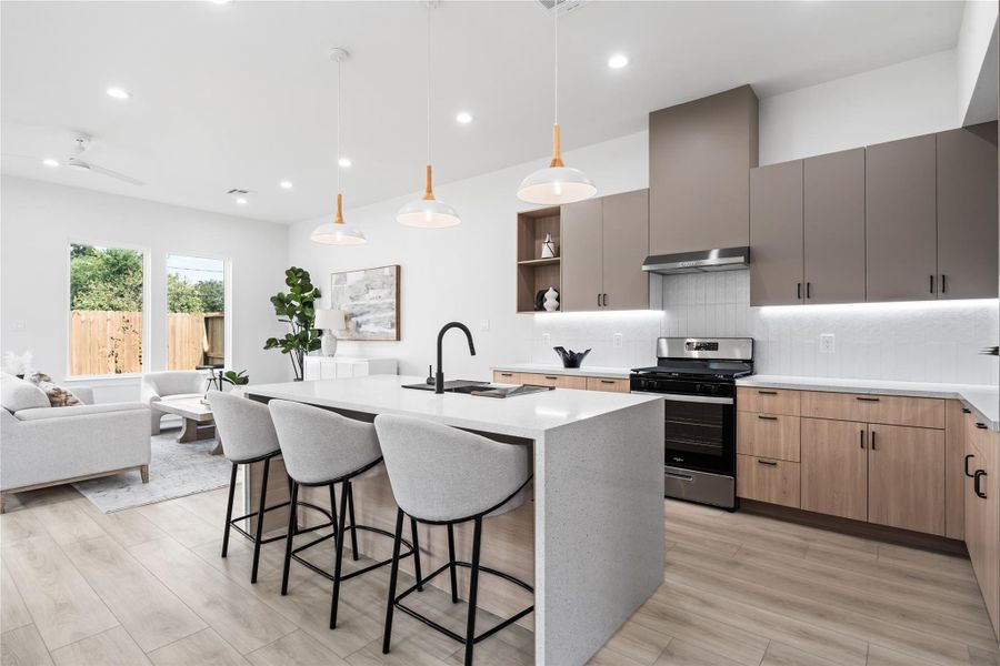 This stunning kitchen features a seamless flow into the living room, creating the perfect space for both everyday living and entertaining. With its modern farmhouse charm and Scandinavian-inspired design, it balances warmth and functionality beautifully. Imagine preparing meals while staying connected to family and guests in this open, inviting layout.