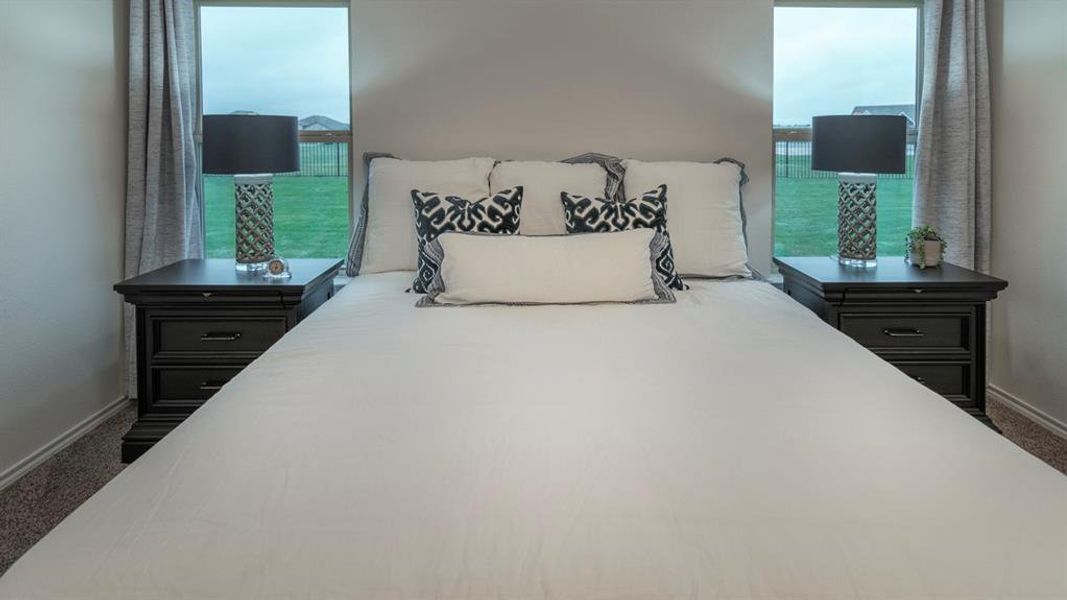 Carpeted bedroom featuring baseboards