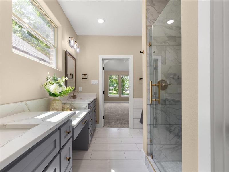 Bathroom with vanity, a marble finish shower, recessed lighting, and light tile patterned floors