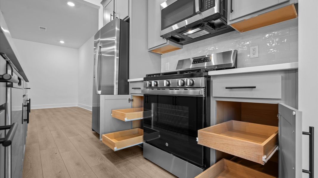 Notable 9-foot island provides generous prep and gathering space in this thoughtfully designed kitchen