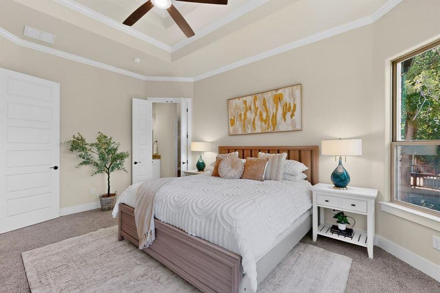Bedroom featuring a tray ceiling with crown molding, recessed lighting, and a ceiling fan