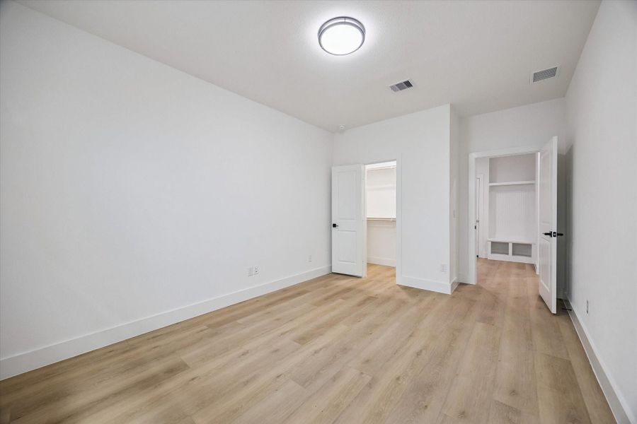 Secondary bedroom with simple, comfortable proportions and neutral palette
