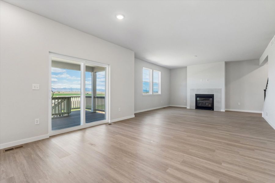 A room with a fireplace and a wood floor. A room with a fireplace and a wood floor.