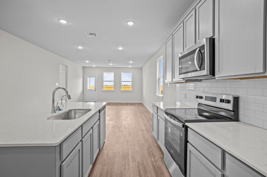 A kitchen with white cabinets.