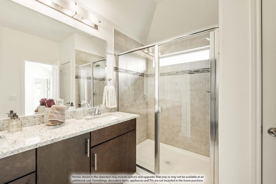 Bathroom with dark wood vanity, granite countertop, large mirror, and glass-enclosed tile shower