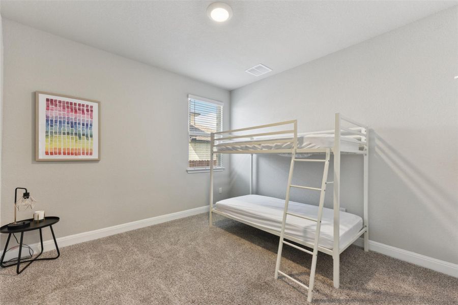 Bedroom featuring carpet and baseboards Bedroom featuring carpet and baseboards