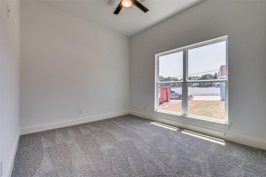 Empty room featuring carpet and ceiling fan