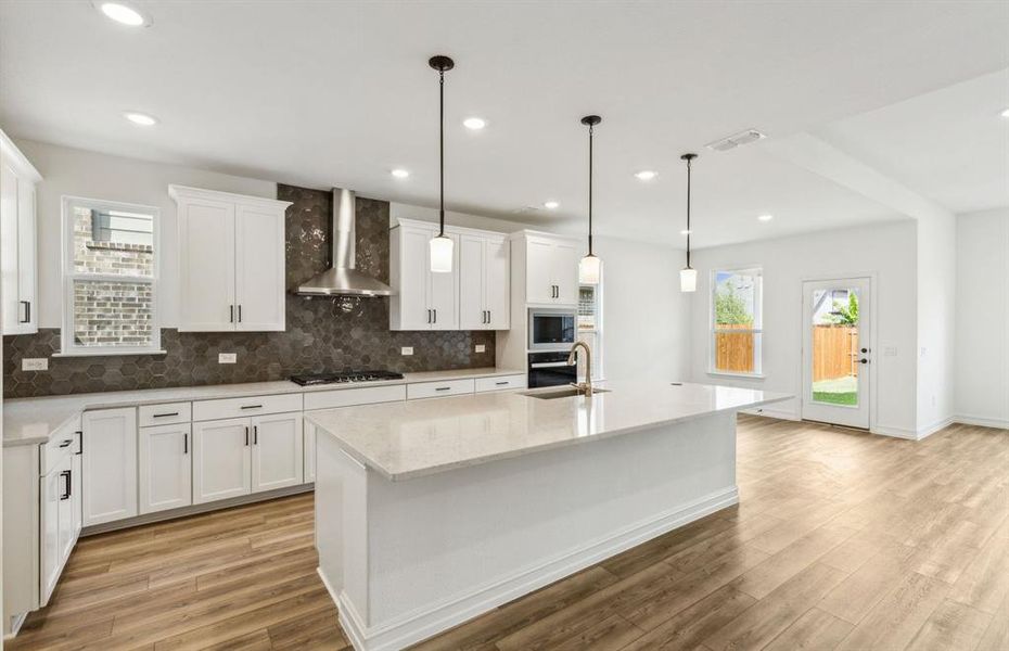 Bright kitchen with oversized island *real home pictured