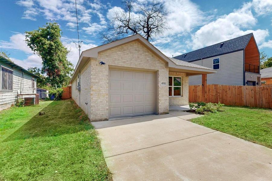 View of front facade with a front lawn and a garage