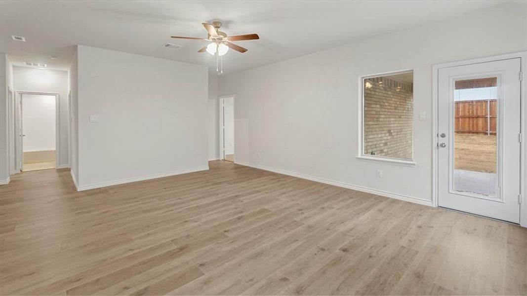 Unfurnished room featuring light wood-style floors and a ceiling fan Unfurnished room featuring light wood-style floors and a ceiling fan
