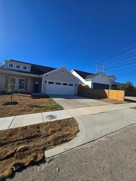 View of front of property featuring concrete driveway, board and batten siding, a garage, and a porch