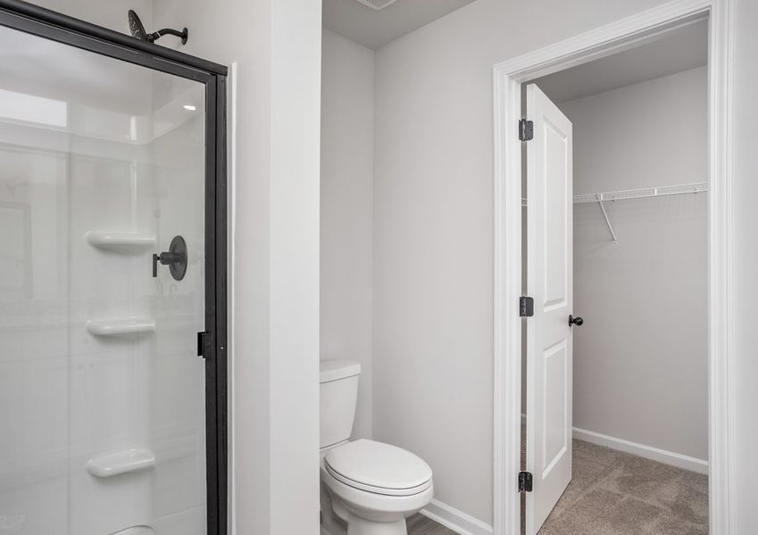 This bathroom has a glass-enclosed shower