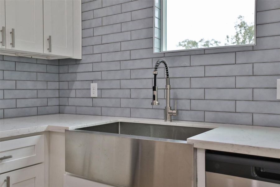 Experience the elegance of a spacious stainless steel undermount sink.