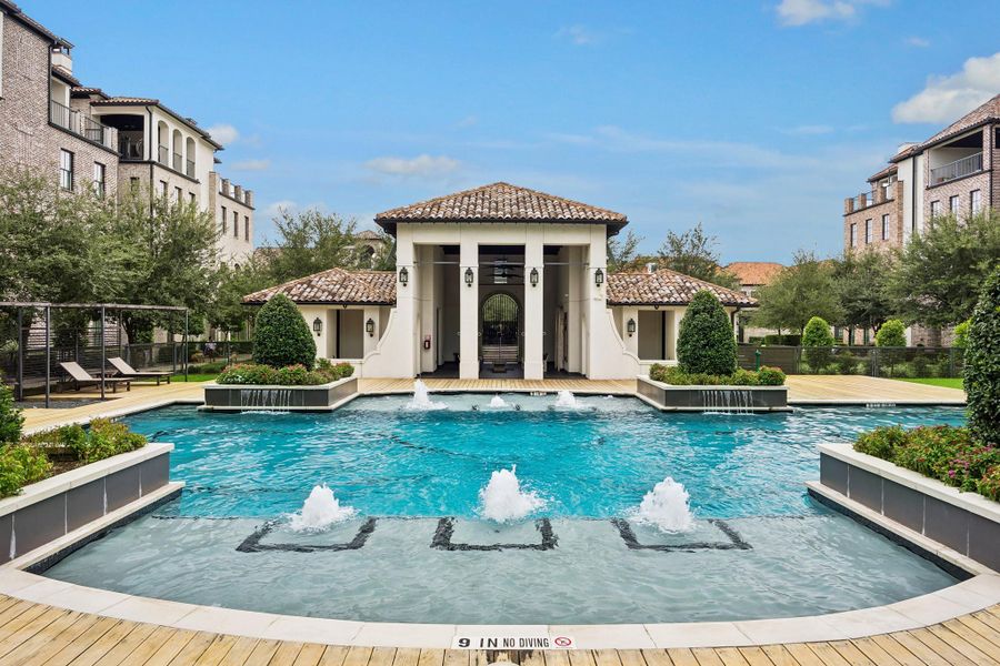 Beautifully landscaped 77-foot community pool, perfect for swimming laps or relaxing.