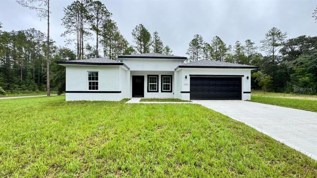 Front exterior of a new home in , Citrus Springs, FL, highlighting curb appeal (Image 1).