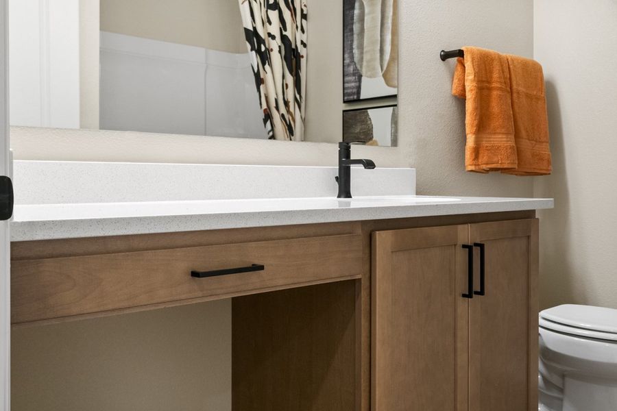 Extended vanity with knee space at secondary bath