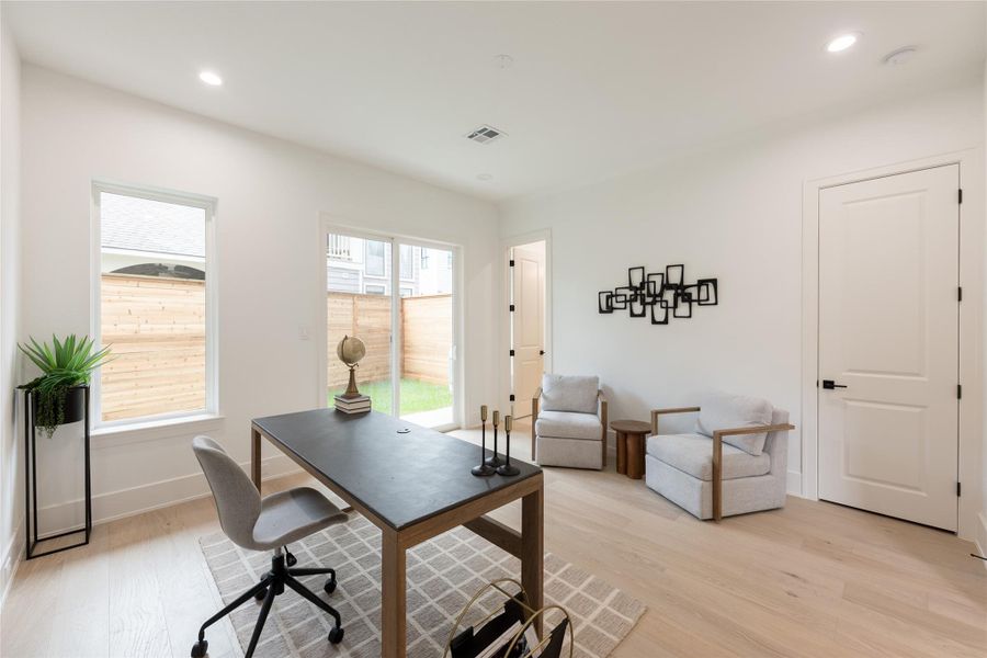 A closer look: twin paneled doors on the interior wall; one concealing the private en suite, the other opening to dedicated storage, while the opposite wall carries a triple-panel slider and a paired casement. Symmetry and utility, sharing equal weight.