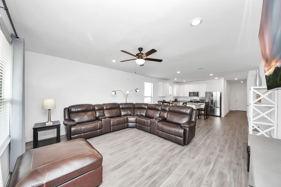 Greeted by open floor plan kitchen/dining/living area
