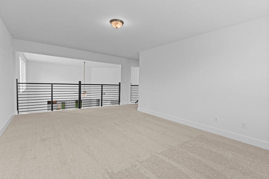 Game room overlooks the main living space below, offering an airy, connected feel and additional room to create a comfortable retreat or recreational hub. Down to your left down the amazing cat walk to the guest bedrooms tucked away!**Image Representative of Plan Only and May Vary as Built**.