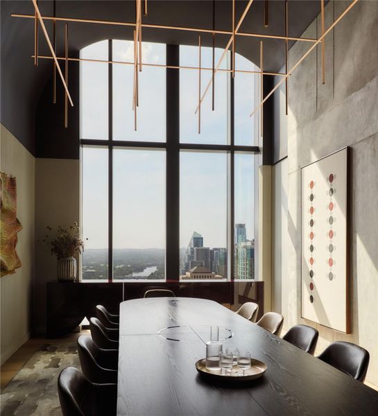 Towering arched windows frame breathtaking cityscape views in this architectural dining room. Towering arched windows frame breathtaking cityscape views in this architectural dining room.