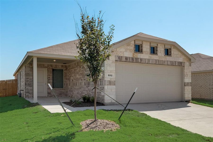 Ranch-style house featuring a front yard and a garage