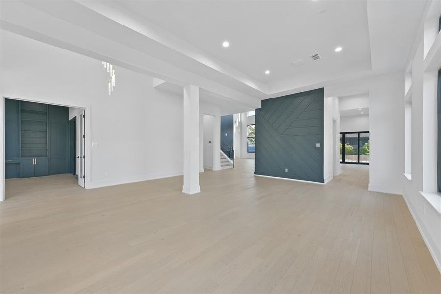 Step through the front door to the formal dining space that offers a double height tray ceiling, great natural light and white oak floors that flow seamlessly throughout. The study/library is featured just off the main entry.