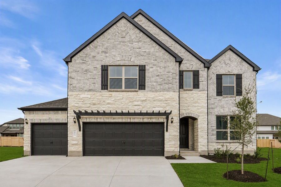 Front exterior of a new home in Bluffview Reserve, Leander, TX, highlighting curb appeal (Image 2). Front exterior of a new home in Bluffview Reserve, Leander, TX, highlighting curb appeal (Image 2).