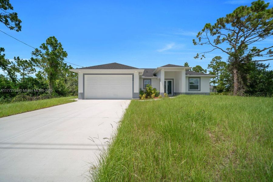 Front exterior of a new home in , Lehigh Acres, FL, highlighting curb appeal (Image 19).