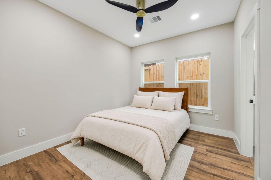 Comfortable secondary bedroom with high ceilings, large windows, and ample closet space. Comfortable secondary bedroom with high ceilings, large windows, and ample closet space.